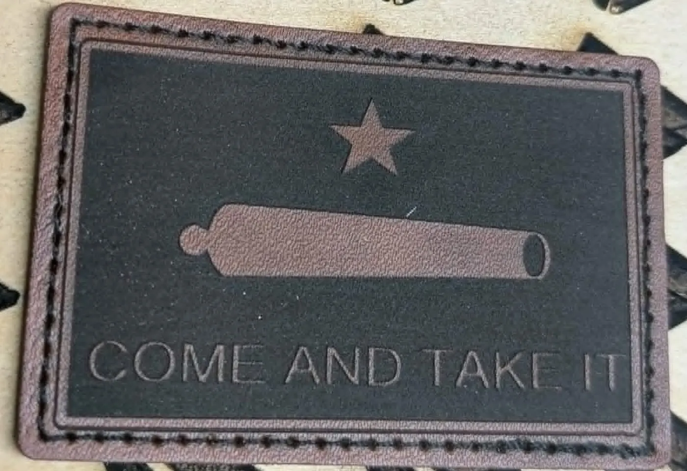 Laser-etched Come and Take It leather patch